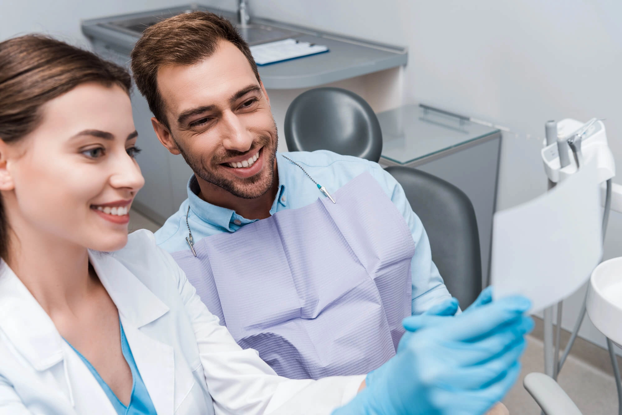 Dentist-48017-showing-patient-an-xray-of-his-teeth
