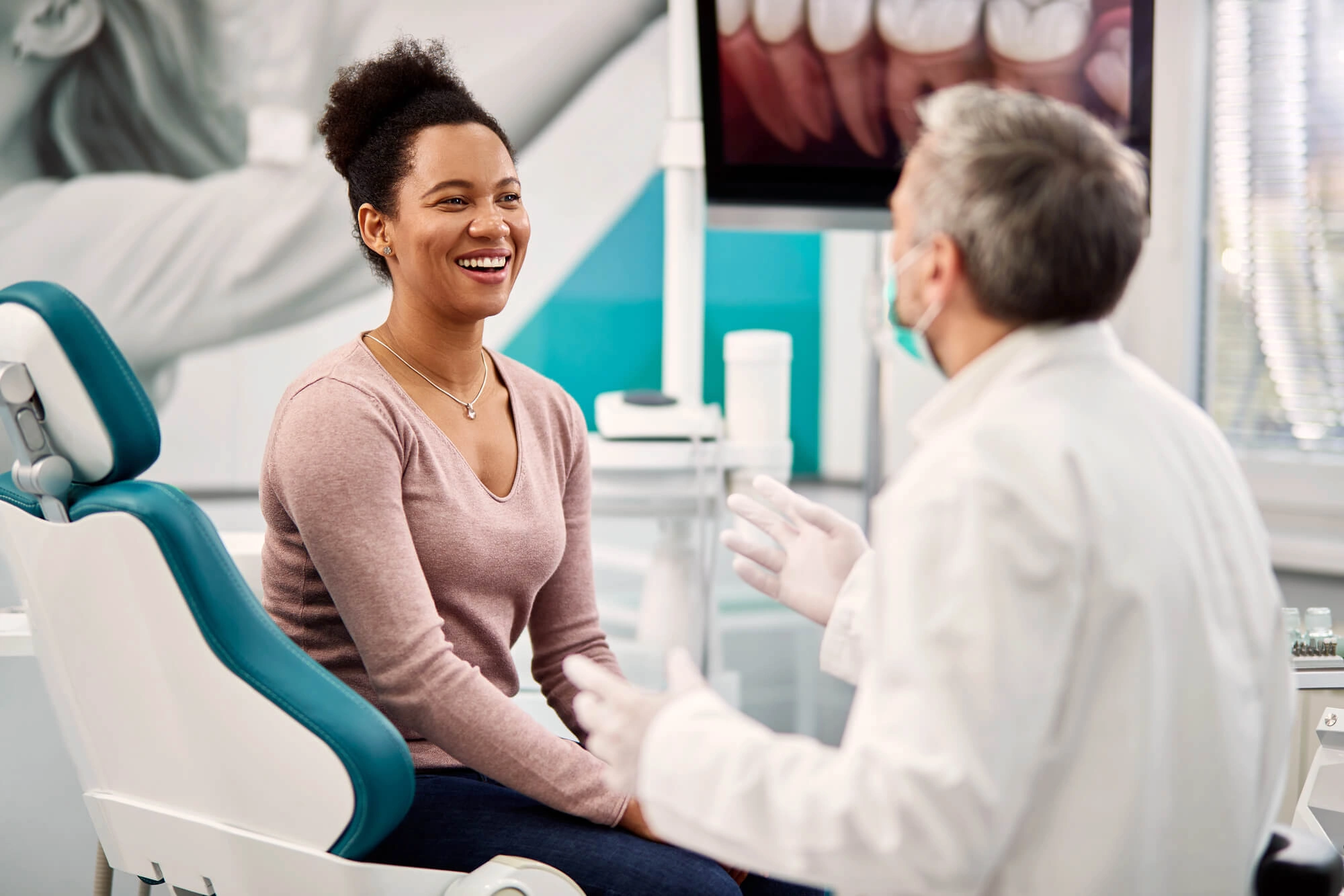 Woman-talking-to-Orthodontist-Clawson 