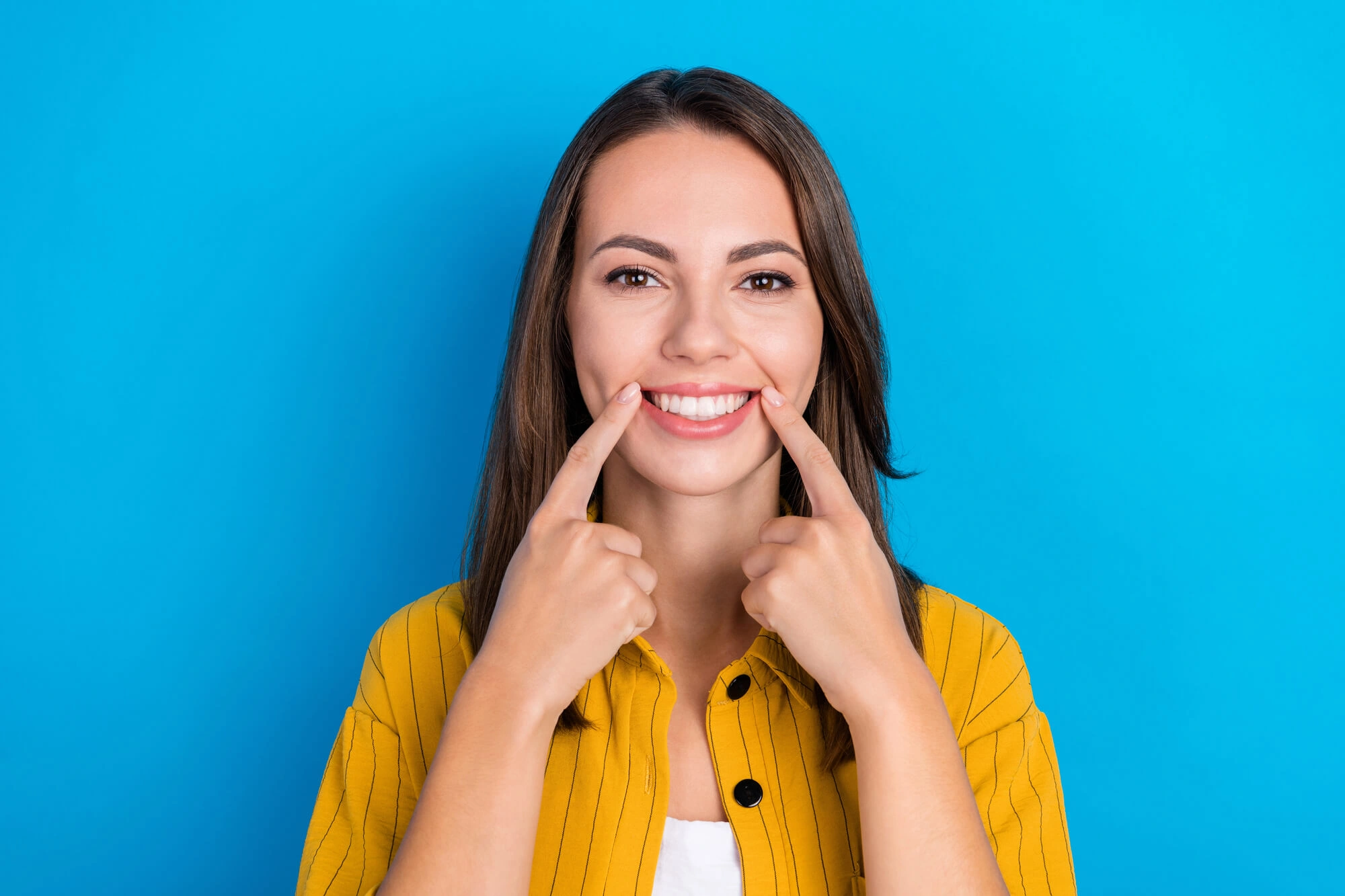 Girl-showing-her-Dental-Implants-Clawson-MI 
