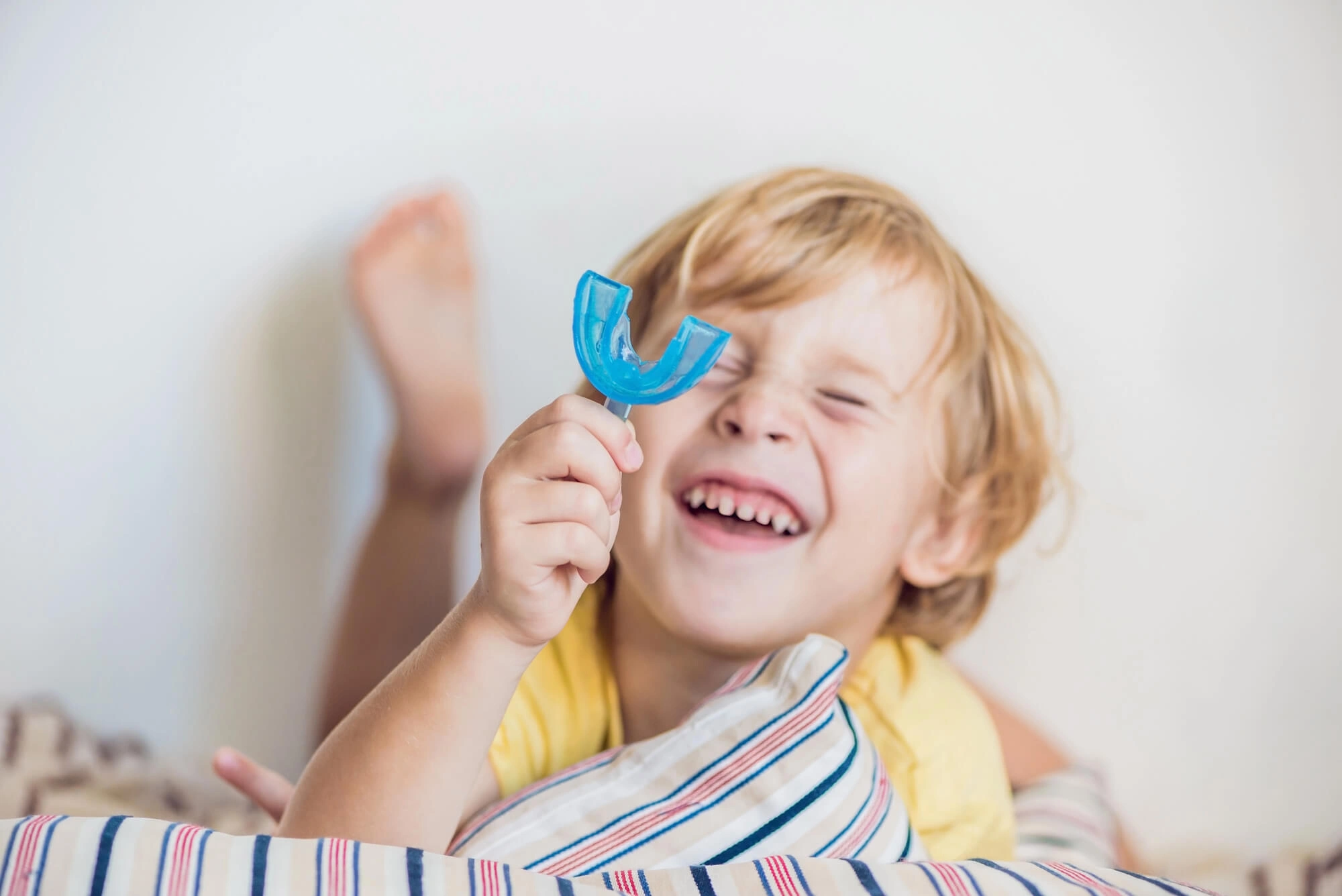 Kid holding a mouthguard by Orthodontist Clawson 